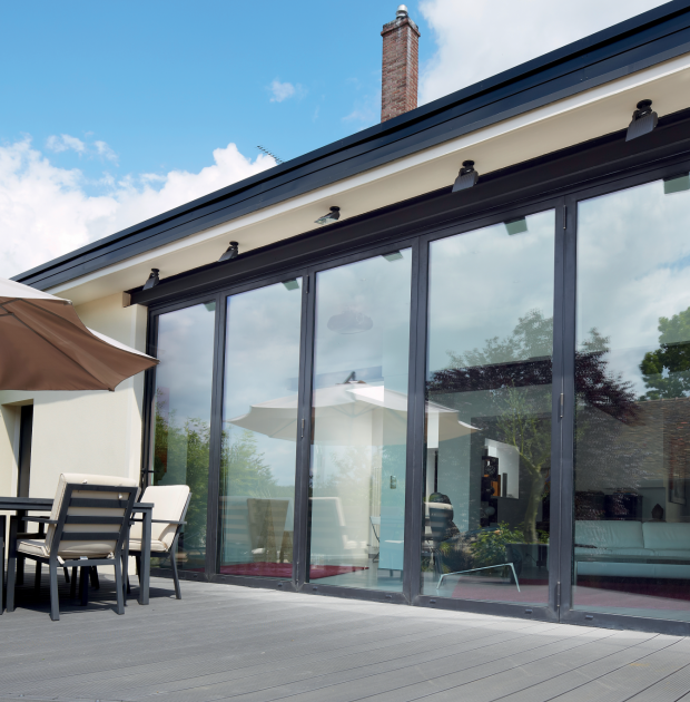 aluminium bifold exterior door with 5 panels, looking out onto a modern patio.
