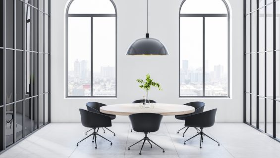 Large, arched aluminium windows in a modern office meeting room.