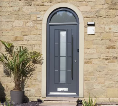 Grey Vermont Rockdoor composite front door, exterior view of a modern home.