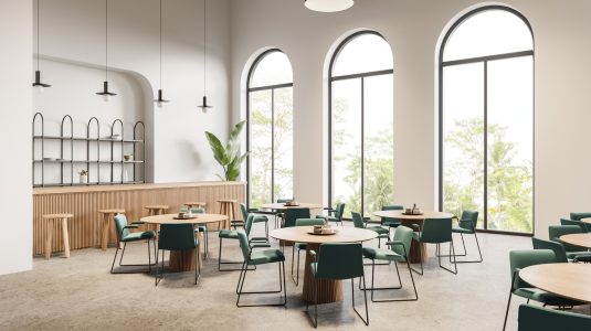 Large, arched windows in a commercial cafe setting.