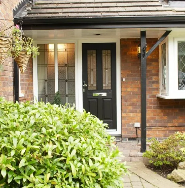 Modern, black composite door with two glass window panels.